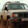 Client Jenn driving over muddy terrain