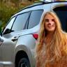 Client Lisa Montoya and her golden retriever next to upgraded SUV